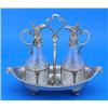 Image 1 : A Victorian oil and vinegar frame, oval with a nulled border, volute terminals and scroll feet, a ce