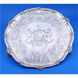 A William IV large round salver with a shaped, moulded and flower chased border and engraved with an