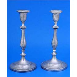 A pair of William IV round candlesticks, the vase shaped capitals, baluster stems and round bases wi