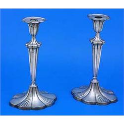A pair of oval lobed candlesticks with fan fluted vase shaped capitals, tapering stems and bases, Sh