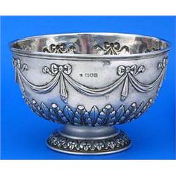 A small round punch bowl embossed with drapery swags, ribbon bows and acanthus, on domed foot, Londo