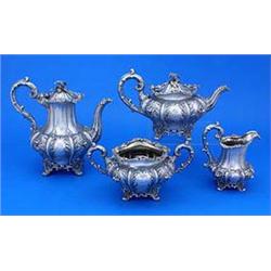 A Victorian four piece tea service, melon fluted and profusely chased and embossed with flowers leav