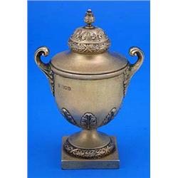 A silver gilt trophy cup and cover, embossed with acanthus and with two flying scroll handles, the d