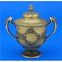 A silver gilt small cup and cover, the campana shaped bowl with an applied band of trailing vines an