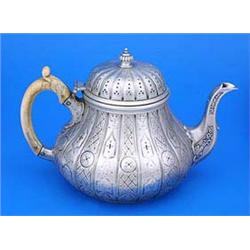 A William IV teapot, of compressed pear shape, engraved with geometric designs and diaper within flu