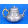Image 1 : A William IV teapot, of compressed pear shape, engraved with geometric designs and diaper within flu