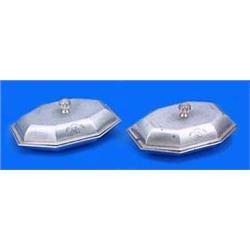 Two very similar George III canted rectangular entree dishes and covers, with moulded borders, bud f