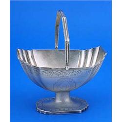 A George III sugar basket, canted rectangular with fluted corners, a reeded swing handle, border and