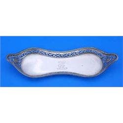 A George III snuffer tray of shaped outline with a beaded border and pierced sides with paterae and.