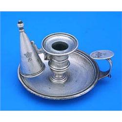 A George IV round chamber candlestick, with a moulded border and engraved with a crest and initial '