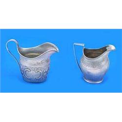 Two George III oval cream jugs, one with a reeded border and angular handle, a bright cut engraved b