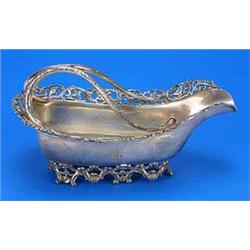 A North American bottle stand, initial 'R' with engraved trailing stem handles, an openwork border o