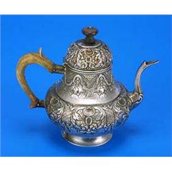 A Continental round embossed teapot with ivory handle and wood finial, 13 cm diameter (5 in)   - 9 o