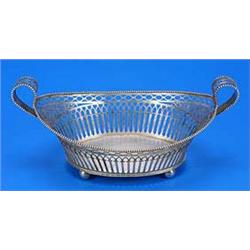 A 19th century Dutch oval cake basket, pierced sides with a beaded border, two pierced loop handles.