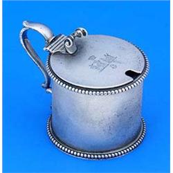 A Victorian drum shaped mustard pot with beaded borders and double scroll handle, the hinged cover e
