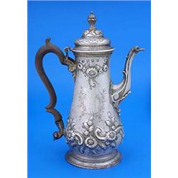 A late George II pear shaped coffee pot embossed with flowers and scrolls and engraved with a cartou