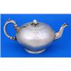 A Victorian bullet shaped teapot, engraved with a crest with a facetted leaf capped spout and flush.