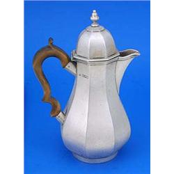 A late Victorian facetted baluster shaped hot water jug in George I style, with a wood handle, the d