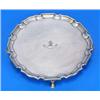 A Victorian round salver with a shaped border on four hoof feet, engraved with a crest and motto, Lo