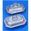 Two canted rectangular entree dishes, covers and handles each with moulded borders, one with a crest