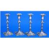 A set of four late George II cast candlesticks, the knopped columns and the shaped square spreading.