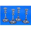 A set of four William IV shaped-square raised candlesticks, with shell and leaf chased capitals and.