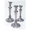 A set of four 19th century candlesticks with shaped round capitals, tapering stems and flower shaped