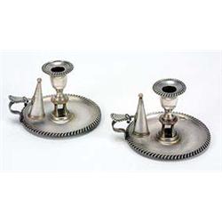 A pair of early 19th century Sheffield round chamber candlesticks with gadrooned borders and extingu