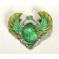 A German plique a jour 'Scarab' brooch, the creature has a green enamelled body and outspread wings.