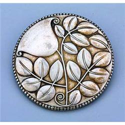 An Art Nouveau circular plated brooch, the design by Josef Hoffmann, embellished in shallow relief w