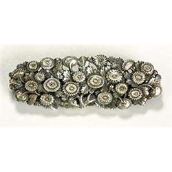 An unusual floral brooch, possibly American in the Japanese manner, of oval shape and formed by a la