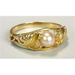 An Art Nouveau pearl-set ring, with central cultured pearl held within a foliate mount that extends.