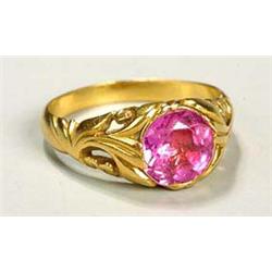 An Art Nouveau pink tourmaline ring, having a central facetted stone and foliate detail on the shank