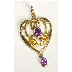 An Art Nouveau gold and amethyst pendant, of open heart shape formed by tendrils and two leaves havi