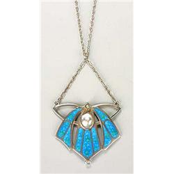 An Art Nouveau enamelled pendant, of winged form with panels of turquoise enamelling over a textured