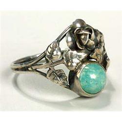 An Arts and Crafts ring, showing influences of the Birmingham school, with a lozenge-shaped panel of