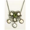 An Arts and Crafts peridot and mother of pearl pendant, having a central peridot cabochon flanked by