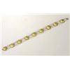 A child's enamelled bracelet, composed of nine flowerform plaques picked out in green and mauve enam