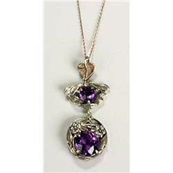 A Bernard Instone Arts and Crafts pendant, of circular shape with a facetted amethyst held within a.