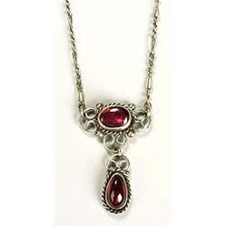 An Arts and Crafts garnet necklace, possibly by the Gaskins, with an oval almandine garnet cabochon.