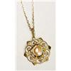 A Liberty & Co gold pendant, of stylised openwork floral form and centred with a plaque of blister p