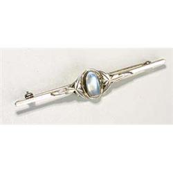 A Liberty and Co Moonstone brooch, with a central oval moonstone cabochon flanked by stylised foliat