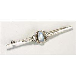 A Liberty and Co Moonstone brooch, with a central oval moonstone cabochon flanked by stylised foliat