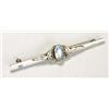 A Liberty and Co Moonstone brooch, with a central oval moonstone cabochon flanked by stylised foliat