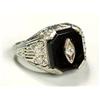 A stylish diamond and black onyx ring, having a rectangular plaque with canted corners with a centra
