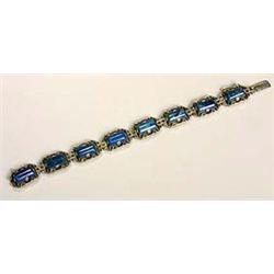 An Art Deco swiss-lapis and marcasite bracelet, composed of eight rectangular plaques with canted co