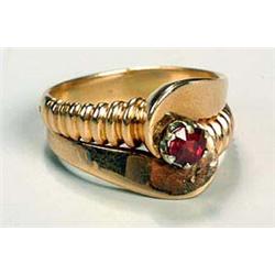 A stylish ring, with alternating ribbed and plain curved band enclosing a garnet-topped doublet, sta