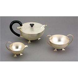 A three-piece silver teaset, by Francis Higgins, comprising a hemispherical teapot with scrolling eb