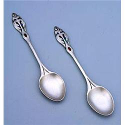 A set of six W. H. Haseler enamelled silver coffee spoons, each with a oval bowl and a slender handl