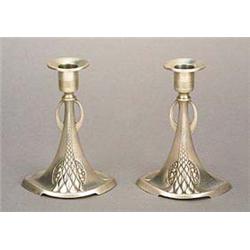 A pair of W.M.F. pewter candlesticks, each with an eliptical base embellished with lobes and panels.